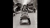 The license plate is almost as large as her automobile, but Miss Mary Bay likes her car because it is easy to park  Miss Bay is shown braving the traffic of Washington edit jpg